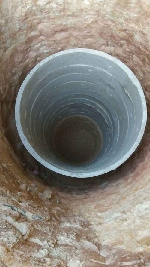 Looking down the shaft of a concrete-ring recharge well