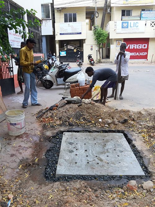ARS team installing a recharge pit beside a city street